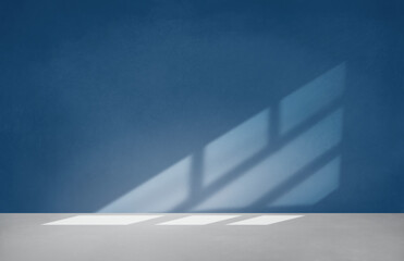 Blue wall in an empty room with concrete floor