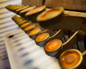 A retro cash register gently rusts in an architectural salvage shop