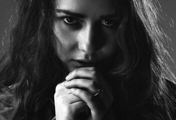 Loneliness concept. Body language, gestures, body psychology. Horizontal black and white image.