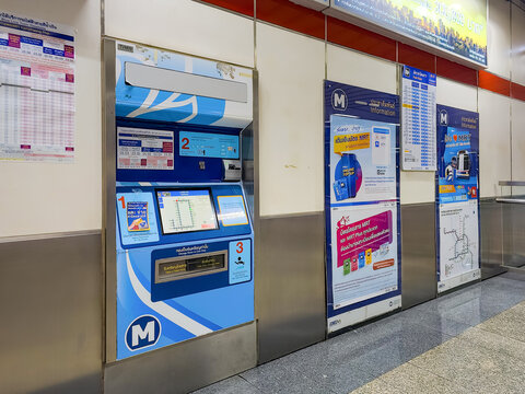 BANGKOK, THAILAND - JUN 28, 2024: Ticket vending machine at Bangkok MRT station, featuring route map, digital display, and instructional signage in Thai and English.