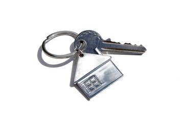 A keychain with a key lies on a white isolated background.	