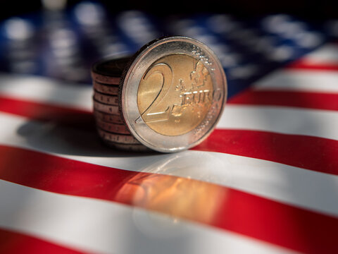 Currency Exchange: European Euro Coin on American Flag