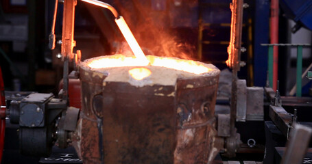 Hard work in the foundry. Pouring molten steel. Liquid steel pouring. Molten metal pouring, metallurgy, steel casting foundry. Steel manufacturing