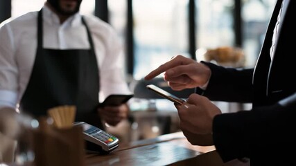 Businessman makes contactless phone payment at coffee shop with layered futuristic HUD interface - Powered by Adobe