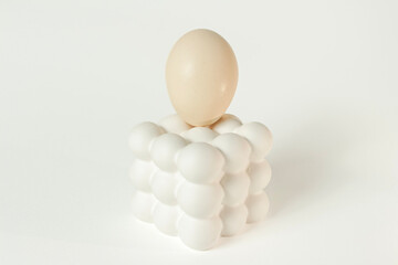 White egg placed on a modern bubble-style egg holder on isolated white background. 