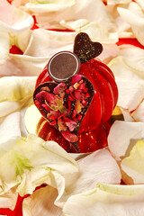 Red heart-shaped cake decorated with rose petals for valentine's day