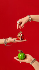 Pastry chefs holding mini apple-shaped cakes on red background