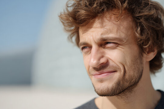 portrait of mischievous slacker positioned to right with subtle smile