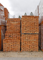 Old Style Orange Bricks at Stacked Pallets Construction Material Storage