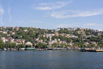 A wide view of the Bosphorus Strait in Istanbul, with the city's skyline and coastal buildings in...