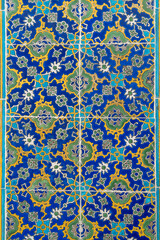 Handmade old Turkish Blue ceramic Tiles on the wall in Istanbul City, Turkey. Close up. Ancient Ottoman patterned Iznik syle design tile composition. Flower patterns on ceramic tiles