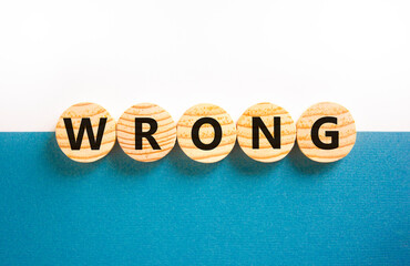 Wrong symbol. Concept word Wrong on beautiful wooden circles. Beautiful white and blue background....