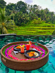 A floating breakfast, typically served in a private pool at a resort