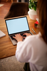 Rear view of a woman typing on the keyboard, empty screen