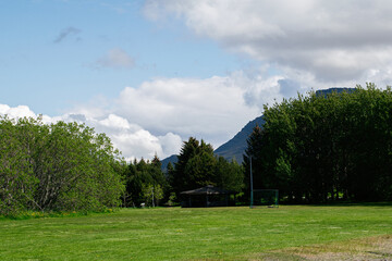 Tranquil park setting in Akranes, Iceland with trees and scenic mountain views