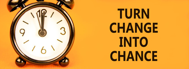 Turn change into chance symbol. Concept words phrase Turn change into chance on beautiful paper. Black alarm clock. Beautiful orange background. Business Turn change into chance concept. Copy space.