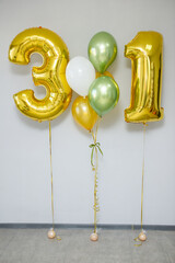 green and gold helium balloons, green chrome balloons for the holiday and gold numbers 31