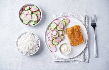 Fried pollock fish with cream sauce and cucumber and radish salad