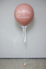 a large pink helium balloon with the inscription "Bye bye Kolomoets"