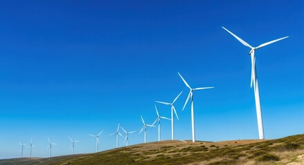 Wind turbines on a hill under a clear blue sky. Renewable energy concept for green power generation. Sustainable electricity production.