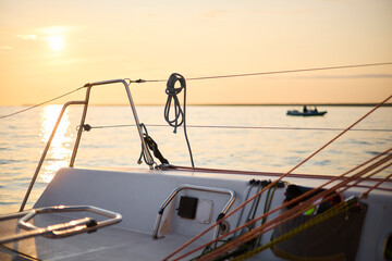 Sailing regatta in the Gulf of Finland at sunset, sailing yacht competing in a race, splashing...