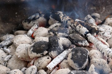 Close-up of coals in the grill, fire, smoke 