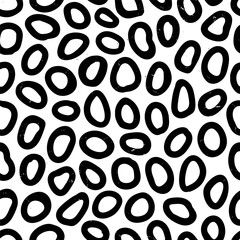 Irregular circle seamless pattern with hand drawn pencil textured ring shapes. Fun background with sketchy scribble spots in black and white colors. To use, drag into swatches panel