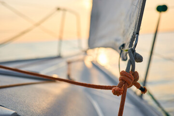 Sailing regatta in the Gulf of Finland at sunset, sailing yacht competing in a race, splashing...
