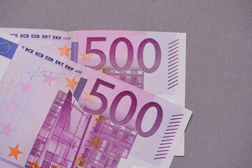 Close-up view of banknotes showing intricate details of 500 euro currency, emphasizing design elements and color patterns
