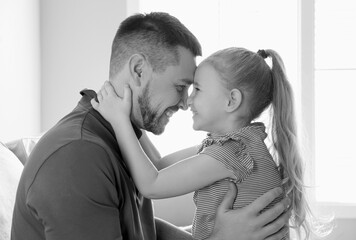 Dad with his daughter at home. Black-and-white toning