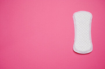 Feminine hygiene product placed on a bright pink background for educational purposes about menstrual health
