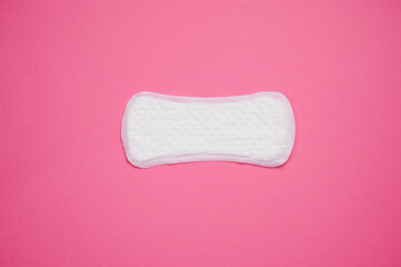 Feminine hygiene product displayed on pink background for educational purposes about menstrual health