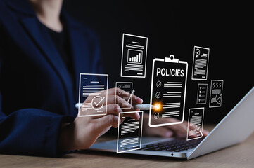 Policy documentation and compliance concept. Businesswoman reviews digital document Policies with...