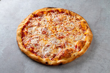 Golden crust surrounds a generous layer of melted cheese and savory tomato sauce, showcasing a classic pizza ready to be enjoyed. The warm aroma invites pizza lovers for a delightful experience