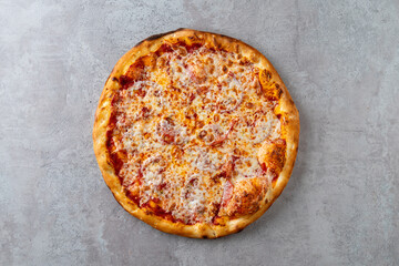 A mouthwatering cheese pizza with a golden, crispy crust sits enticingly on a textured surface. Bubbly melted cheese and rich tomato sauce promise a delightful culinary experience