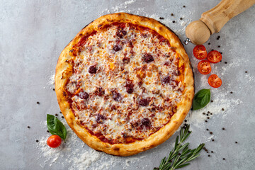 This artisanal pizza, generously covered with melted cheese and vibrant toppings, sits on a...