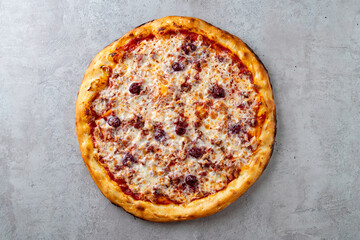 A classic pepperoni pizza with a perfectly baked crust sits on a smooth light gray surface, showcasing melted cheese and flavorful toppings, inviting a cozy dining experience