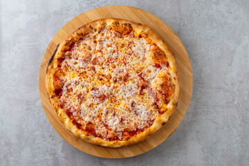 A mouthwatering cheese pizza sits on a wooden board, its crust golden and crispy. The gooey melted cheese invites sharing while the aroma fills the air with comfort and joy