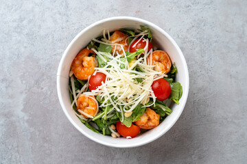 Juicy shrimp mixed with crisp greens and cherry tomatoes create a delightful dish. Enhanced with shaved cheese, this salad is a perfect light meal for warm days