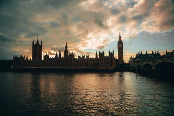 Fototapete Londoner Roter Bus Iconic view of Big Ben with a red double-decker bus and the London Eye in the background on a cloudy day in London.  © Luk