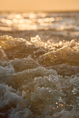 Seething water from under a boat at sunset
