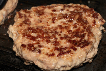 Close up of home made beef burger being griddle fried