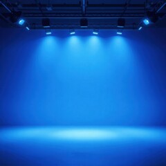 A brightly lit empty studio or stage features powerful blue spotlights illuminating a vast background, creating a dramatic and versatile space for various productions.
