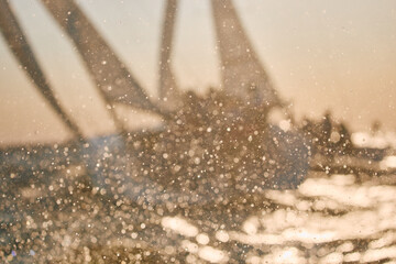 Sailing regatta in the Gulf of Finland at sunset, two sailing yachts competing in a race, splashing...