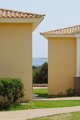 Ocean view through a gap between two houses