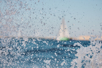 Sailing regatta in the Gulf of Finland at sunset, sailing yacht competing in a race, splashing...