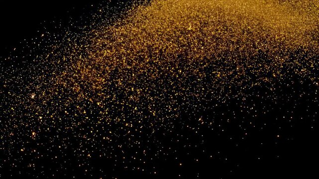 A shower of fine golden glitter particles scattered across a stark black background, creating a shimmering and luxurious abstract texture. Concept of celebration and glamour