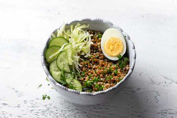Nutritious Buckwheat Bowl with Fresh Cucumber, Cabbage, and Egg