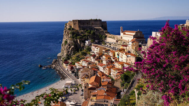 Aerial view of Scilla, Calabria, a picturesque village on the Ionian coast of Italy, featuring the Ruffo Castle, colorful houses, and the blue sea