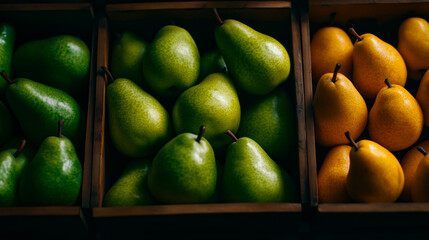 Yellow and green pears sorted in wooden compartments
